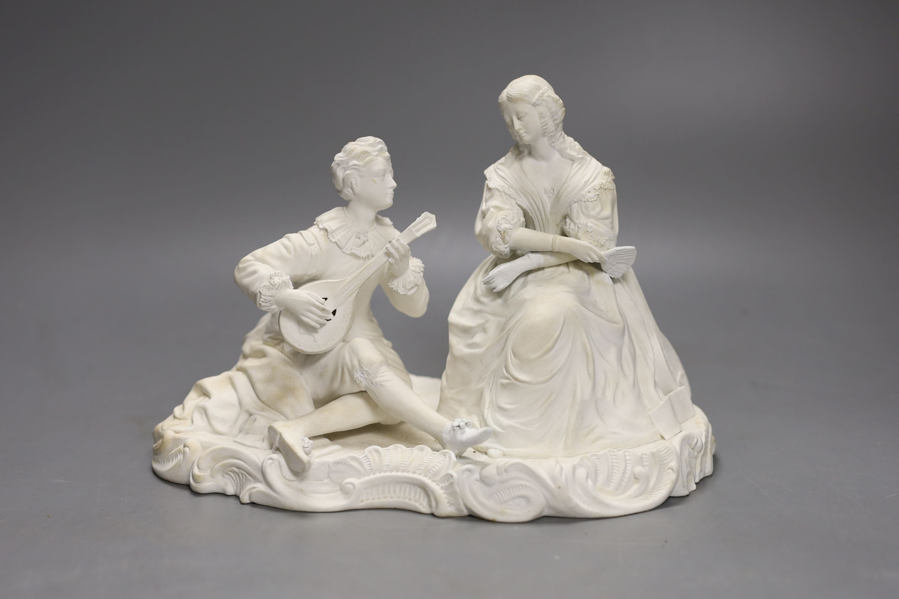 A 19th century Minton biscuit group of a boy with a lute and a girl with a fan, 22cm wide